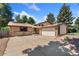 Charming home featuring brick accents, a two-car garage, and mature trees at 12408 E Ohio Ave, Aurora, CO 80012