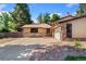 Traditional single-story home with brick accents, large driveway, and manicured front yard at 12408 E Ohio Ave, Aurora, CO 80012