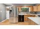 Updated kitchen featuring stainless steel refrigerator and natural wood cabinets at 12408 E Ohio Ave, Aurora, CO 80012