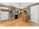 Well-lit kitchen featuring stainless steel appliances and wood cabinets at 12408 E Ohio Ave, Aurora, CO 80012