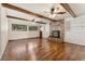 Inviting living room with wood beams, a brick fireplace, and hardwood floors at 12408 E Ohio Ave, Aurora, CO 80012