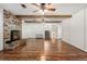 Open-concept living room featuring a brick fireplace, hardwood floors, and natural light at 12408 E Ohio Ave, Aurora, CO 80012