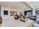 Open-concept basement featuring golf simulator, living, and decor areas at 13812 Honey Hush Trl, Parker, CO 80134