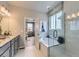 Charming bathroom featuring a bathtub, a glass-enclosed shower, and a neutral color palette at 13812 Honey Hush Trl, Parker, CO 80134