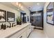 Modern bathroom with a dual sink vanity, quartz countertops, and a luxurious glass enclosed shower at 13812 Honey Hush Trl, Parker, CO 80134