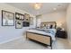 Well-lit bedroom with cozy carpeting, blacked framed art, and a designer bed frame at 13812 Honey Hush Trl, Parker, CO 80134