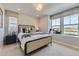 Well-lit bedroom with cozy carpeting, large window with scenic view, and a designer bed frame at 13812 Honey Hush Trl, Parker, CO 80134
