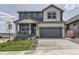 Inviting two-story home boasting a stylish mix of siding and brick, complemented by a well-manicured lawn and a spacious driveway at 13812 Honey Hush Trl, Parker, CO 80134