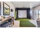 Golf simulator space with putting green and bar table at 13812 Honey Hush Trl, Parker, CO 80134