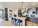 Contemporary kitchen with a center island with seating and pendant lights, featuring stainless steel appliances and sleek cabinetry at 13812 Honey Hush Trl, Parker, CO 80134