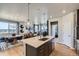 Bright kitchen with stainless steel appliances and an open layout connects to the dining and living areas at 13812 Honey Hush Trl, Parker, CO 80134