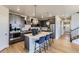 Modern kitchen featuring stainless steel appliances, a center island with seating, and stylish pendant lighting at 13812 Honey Hush Trl, Parker, CO 80134