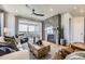 Bright living room with a modern fireplace, stylish furniture, and a sliding glass door to an outdoor balcony at 13812 Honey Hush Trl, Parker, CO 80134