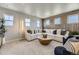 Spacious living room with modern decor, large windows, and a comfortable sectional sofa at 13812 Honey Hush Trl, Parker, CO 80134