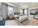 Serene main bedroom featuring tray ceilings, large windows, and a luxurious king-size bed with decorative pillows at 13812 Honey Hush Trl, Parker, CO 80134