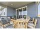 Spacious covered patio with seating and dining areas for outdoor enjoyment at 13812 Honey Hush Trl, Parker, CO 80134