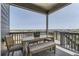 Covered patio with dining set and views of the surrounding neighborhood at 13812 Honey Hush Trl, Parker, CO 80134