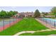 Community view featuring a pool, tennis court, green lawn, and well-maintained townhomes at 4231 S Fairplay Cir # E, Aurora, CO 80014