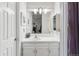 Bright bathroom with white vanity, large mirror and modern lighting fixtures at 4231 S Fairplay Cir # E, Aurora, CO 80014