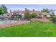 Exterior view of townhomes with a well-manicured lawn, showcasing a serene community living at 4231 S Fairplay Cir # E, Aurora, CO 80014
