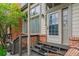 Charming home entrance with a brick facade, wooden steps, and a welcoming front door at 4231 S Fairplay Cir # E, Aurora, CO 80014