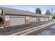 Row of townhome garages featuring neutral doors and red brick accents, offering secure parking at 4231 S Fairplay Cir # E, Aurora, CO 80014