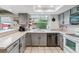 Bright kitchen featuring gray cabinets, stainless steel appliances, and a large window at 4231 S Fairplay Cir # E, Aurora, CO 80014