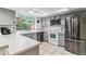 Well-lit kitchen boasts stainless steel appliances, gray cabinetry, and a bright window at 4231 S Fairplay Cir # E, Aurora, CO 80014