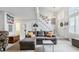 Bright living room featuring a staircase, high ceilings, neutral color palette and comfortable gray sofa at 4231 S Fairplay Cir # E, Aurora, CO 80014