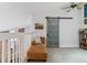 Cozy loft area with a comfortable chaise lounge, unique sliding barn door and shelves at 4231 S Fairplay Cir # E, Aurora, CO 80014