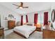 Charming main bedroom with wood furnishings, red curtains and ample natural light at 4231 S Fairplay Cir # E, Aurora, CO 80014