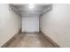 Empty garage interior with white walls and concrete floor at 4862 E Kentucky Ave # D, Denver, CO 80246