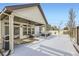 Covered patio with a grilling area and snowy backyard at 5232 Truckee St, Denver, CO 80249