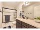 Bathroom with tub/shower combo and dark brown vanity at 5232 Truckee St, Denver, CO 80249