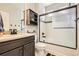 Bathroom with a shower/tub combo, dark brown vanity, and modern fixtures at 5232 Truckee St, Denver, CO 80249