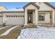 House exterior showcasing a front door and attached garage at 5232 Truckee St, Denver, CO 80249