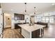 Open kitchen features an island with granite countertops and dark cabinetry at 5232 Truckee St, Denver, CO 80249