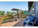 Back deck with table and chairs and blue cushioned seating area at 3491 Kassler Pl, Westminster, CO 80031