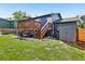 Backyard featuring a deck, shed, lawn, and garden beds at 3491 Kassler Pl, Westminster, CO 80031