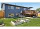 Backyard featuring a deck, lawn, and garden beds at 3491 Kassler Pl, Westminster, CO 80031