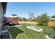 Large backyard with a deck, lawn, and garden beds at 3491 Kassler Pl, Westminster, CO 80031