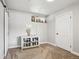Cozy basement space with carpet, sliding barn door, and storage at 3491 Kassler Pl, Westminster, CO 80031