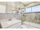 Bathroom featuring stone tiled shower with glass door and modern vanity at 3491 Kassler Pl, Westminster, CO 80031