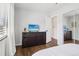 Bedroom featuring hardwood floors, TV and closet with mirrored doors at 3491 Kassler Pl, Westminster, CO 80031