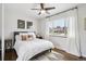 Bright bedroom with white linens, wood floors, and ceiling fan at 3491 Kassler Pl, Westminster, CO 80031
