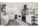 Well-appointed kitchen features white cabinets, stainless steel appliances and breakfast bar at 3491 Kassler Pl, Westminster, CO 80031