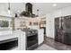 Spacious kitchen showcasing modern stainless appliances, white cabinetry and connecting living space at 3491 Kassler Pl, Westminster, CO 80031