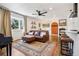 Inviting living room featuring a leather couch, hardwood floors, and ample natural light at 3491 Kassler Pl, Westminster, CO 80031