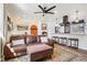 Open-concept living room with hardwood floors, leather seating, and view into the kitchen at 3491 Kassler Pl, Westminster, CO 80031