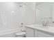 Clean bathroom with a shower over the tub and vanity with a sink, toilet, and mirror at 8295 Snake River St, Littleton, CO 80125